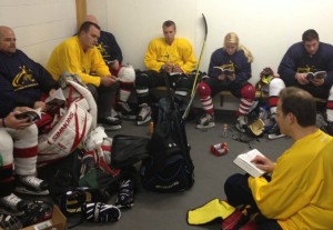 Randazzo (bottom, right) leads devotional time during FCA Hockey adult clinics and has witnessed its impact on attendees.