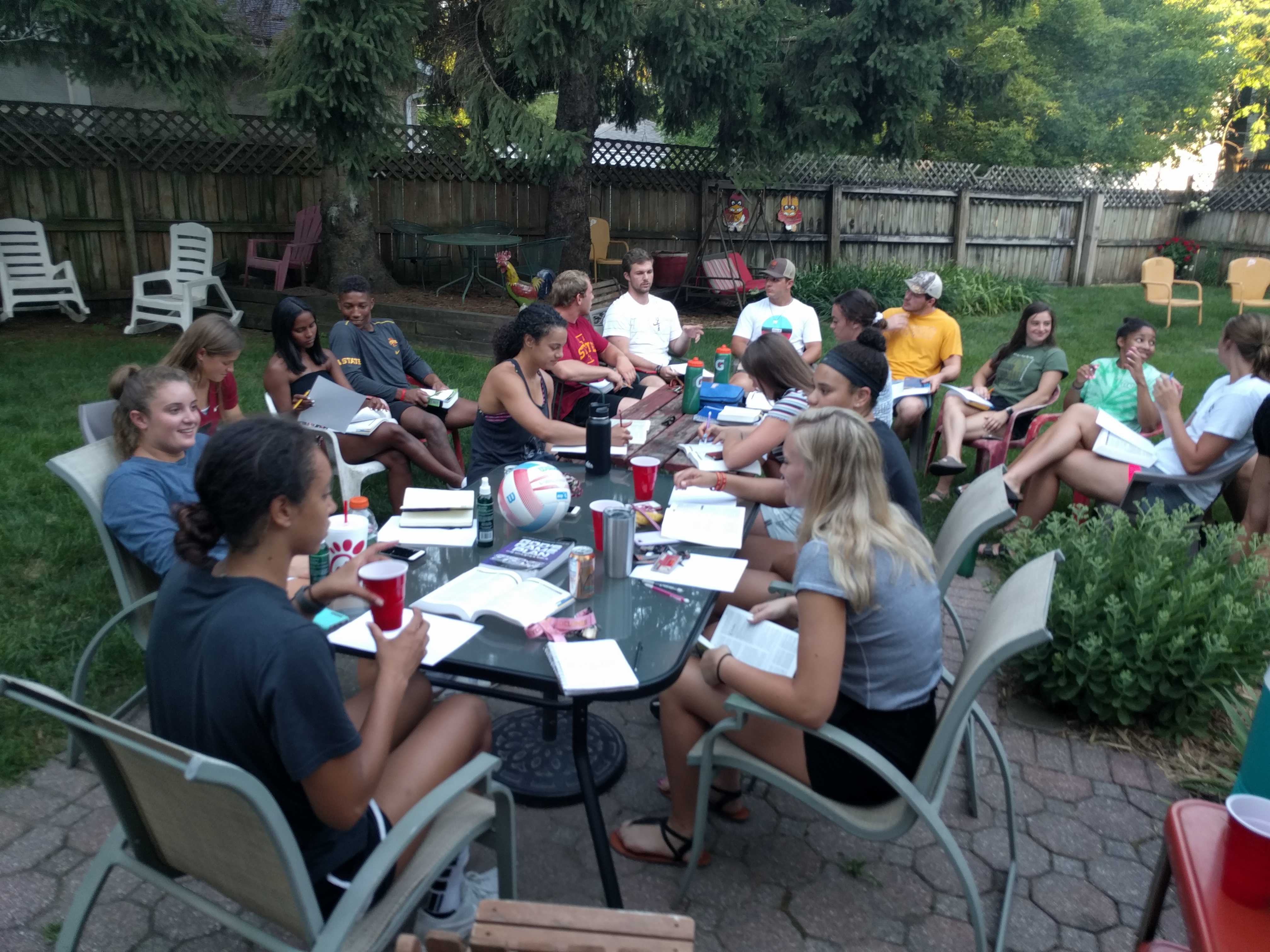 Brock in the cream color shirt at the end of the table with cap on 