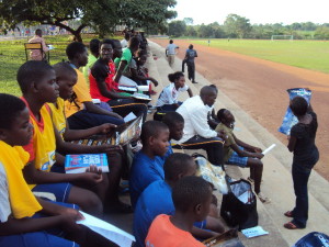 Nambawa speaking to the Ndejje University Luwero FCA Huddle.