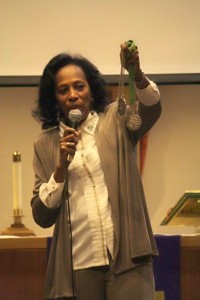 Olympian great Madeline Manning Mims shows her Olympic medals while reminding attendees the true achievements are received through Christ.