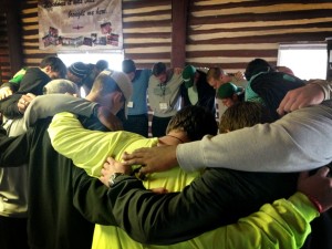 UNC Charlotte Huddle members pray at their 2014 Winter Blitz event.