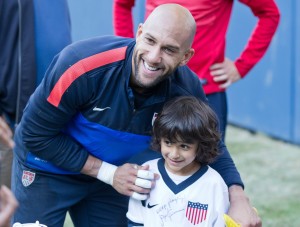 Howard poses with a young fan while training with the United States men's national team.